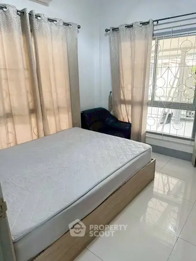 Cozy bedroom with natural light and modern furnishings