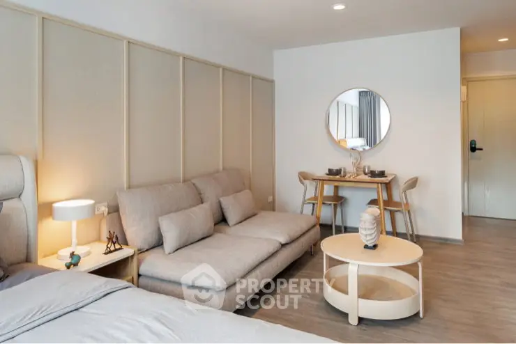 Modern living room with cozy sofa and dining area in stylish apartment.