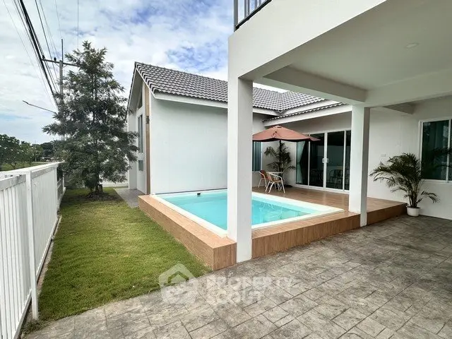 Modern home with private pool and spacious patio, perfect for outdoor relaxation.