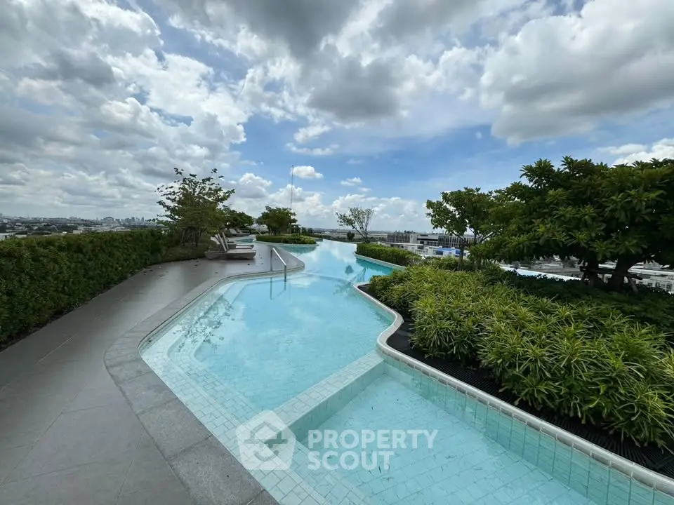 Stunning rooftop pool with panoramic city views and lush greenery