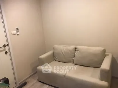 Cozy small living room with beige sofa and minimalist decor