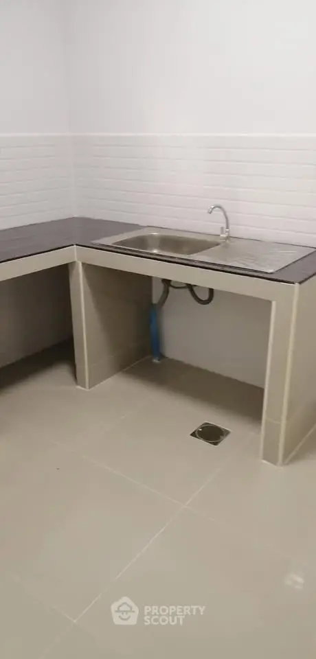 Modern kitchen with sleek countertops and stainless steel sink