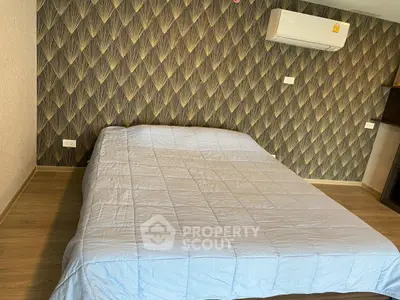 Modern bedroom with stylish wallpaper and air conditioning unit.