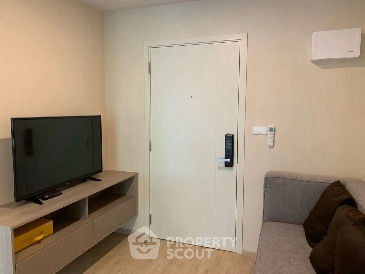 Modern living room with sleek TV setup and cozy sofa, perfect for relaxation.