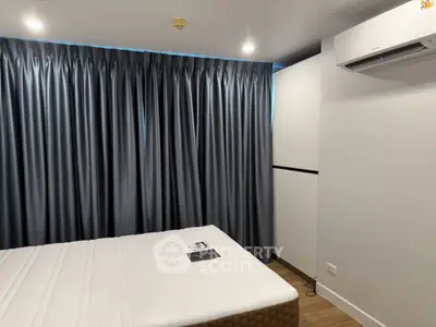 Modern bedroom with sleek curtains and air conditioning unit
