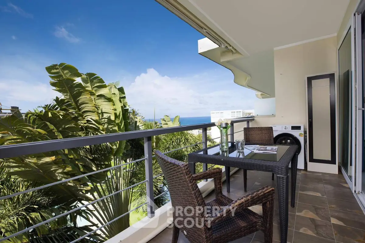 Stunning balcony with ocean view, perfect for relaxation and outdoor dining.