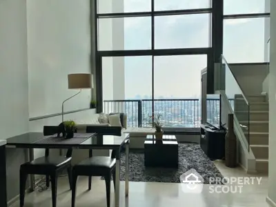 Modern living room with large windows and city view, featuring stylish furniture and open layout.