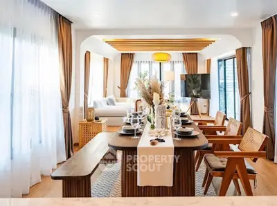Luxurious open-plan living and dining area with elegant decor and natural light