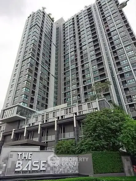 Modern high-rise condominium with sleek design and lush greenery at The Base Park East.