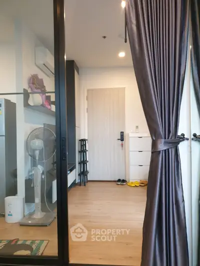 Modern apartment entrance with sleek design and wooden flooring