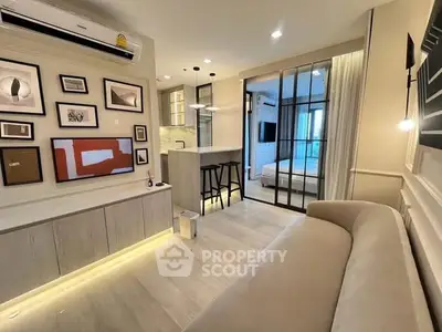 Modern living room with stylish decor and open layout leading to bedroom