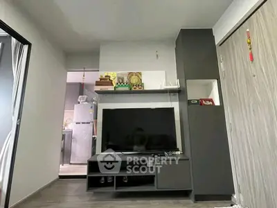 Modern living room with sleek TV unit and open kitchen view