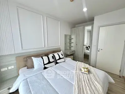 Modern bedroom with stylish decor and cozy bedding in a contemporary apartment.