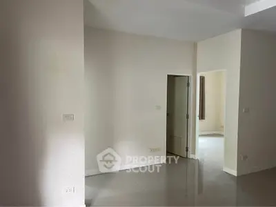 Spacious empty room with glossy tiled floor and neutral walls, ready for customization.