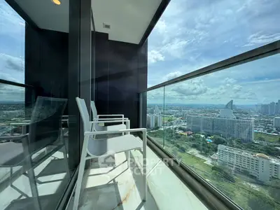 Stunning high-rise balcony with panoramic city views and modern seating.