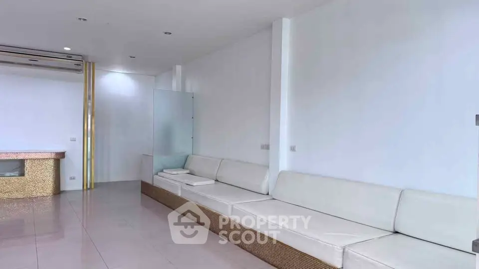 Spacious modern living room with sleek white seating and minimalist design