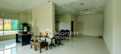 Spacious living room with elegant decor and large windows offering natural light.