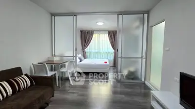 Modern studio apartment with sliding glass doors and stylish furnishings