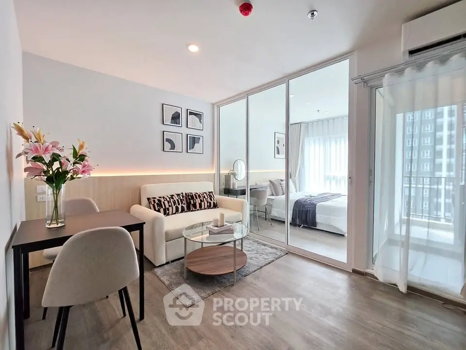 Modern living room with stylish decor and bedroom view in a contemporary apartment.