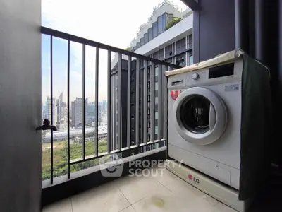 Modern balcony with washing machine and city view, perfect for urban living.