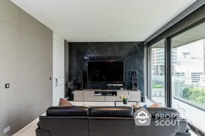 Luxurious living room with sleek black marble wall, modern entertainment system, and plush leather sofa, complemented by natural light from large windows.