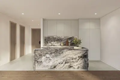 Luxurious modern kitchen with marble island and sleek cabinetry in a contemporary apartment.