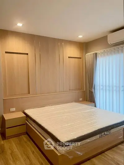 Modern bedroom with wooden accents and natural light, featuring a sleek bed and stylish curtains.
