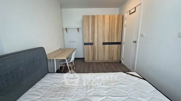 Modern bedroom with stylish wardrobe and cozy workspace