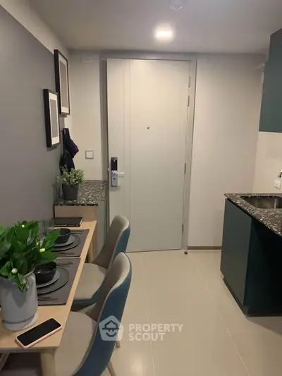 Modern compact kitchen with dining area in stylish apartment