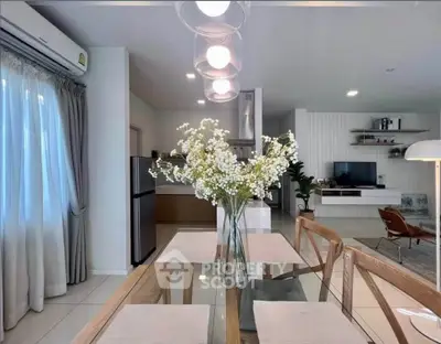 Modern open-plan living and dining area with stylish decor and natural light.