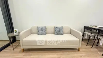 Modern living room with stylish beige sofa and elegant dining area