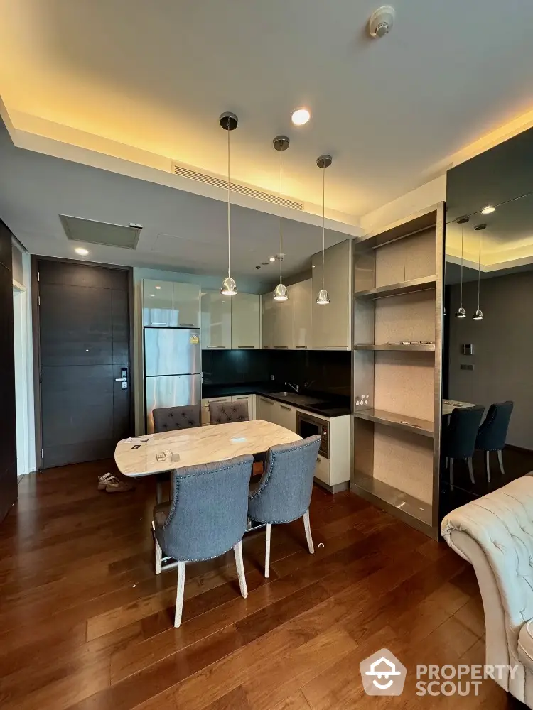 Modern kitchen with sleek design, open layout, and stylish dining area in luxury apartment.