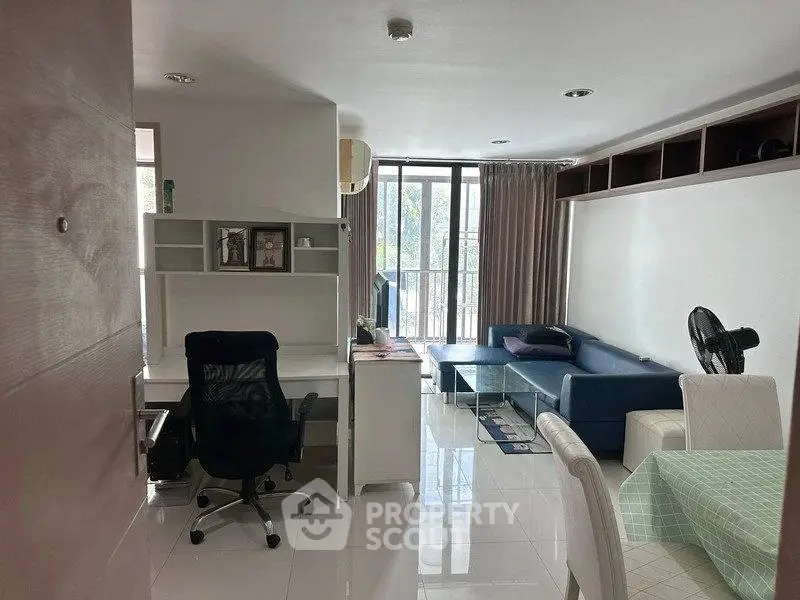 Modern living room with study area, sleek furniture, and large windows for natural light.