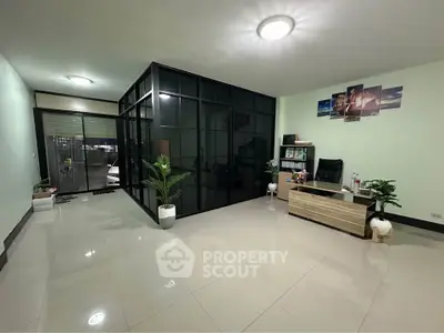 Spacious modern living room with sleek glass partition and minimalist decor