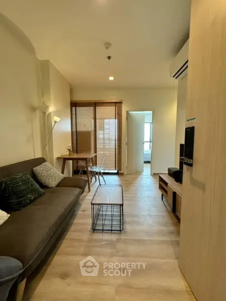 Modern living room with cozy sofa and stylish decor in open layout apartment.