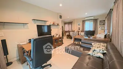 Spacious living room with modern furniture and ample natural light, perfect for family gatherings.