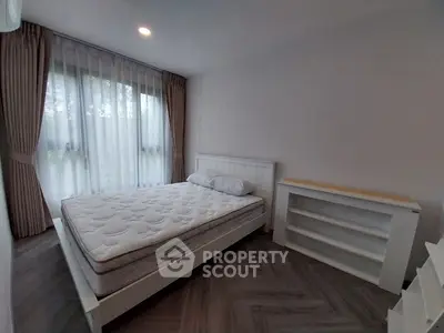 Spacious modern bedroom with stylish decor and ample natural light