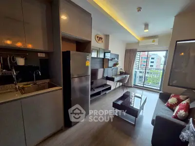 Modern living room with sleek kitchen and balcony view in urban apartment.
