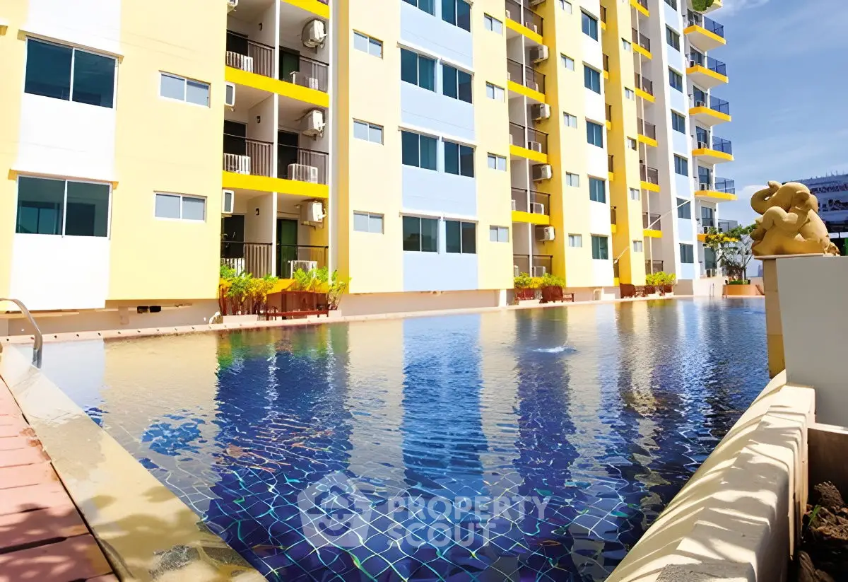 Modern apartment building with inviting pool and sunny exterior