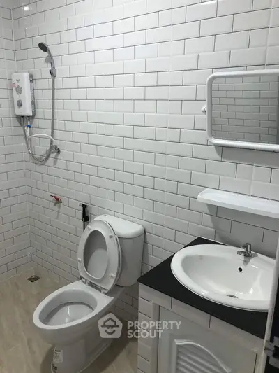 Modern bathroom with white subway tiles and sleek fixtures