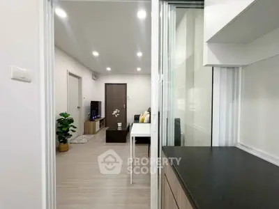Modern apartment interior with open layout, sleek kitchen, and cozy living area.