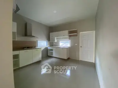 Spacious modern kitchen with sleek cabinetry and gas stove