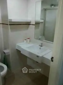 Compact bathroom with modern sink and mirror, ideal for small spaces.