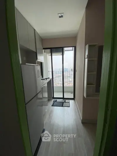 Modern kitchen with balcony view in high-rise apartment