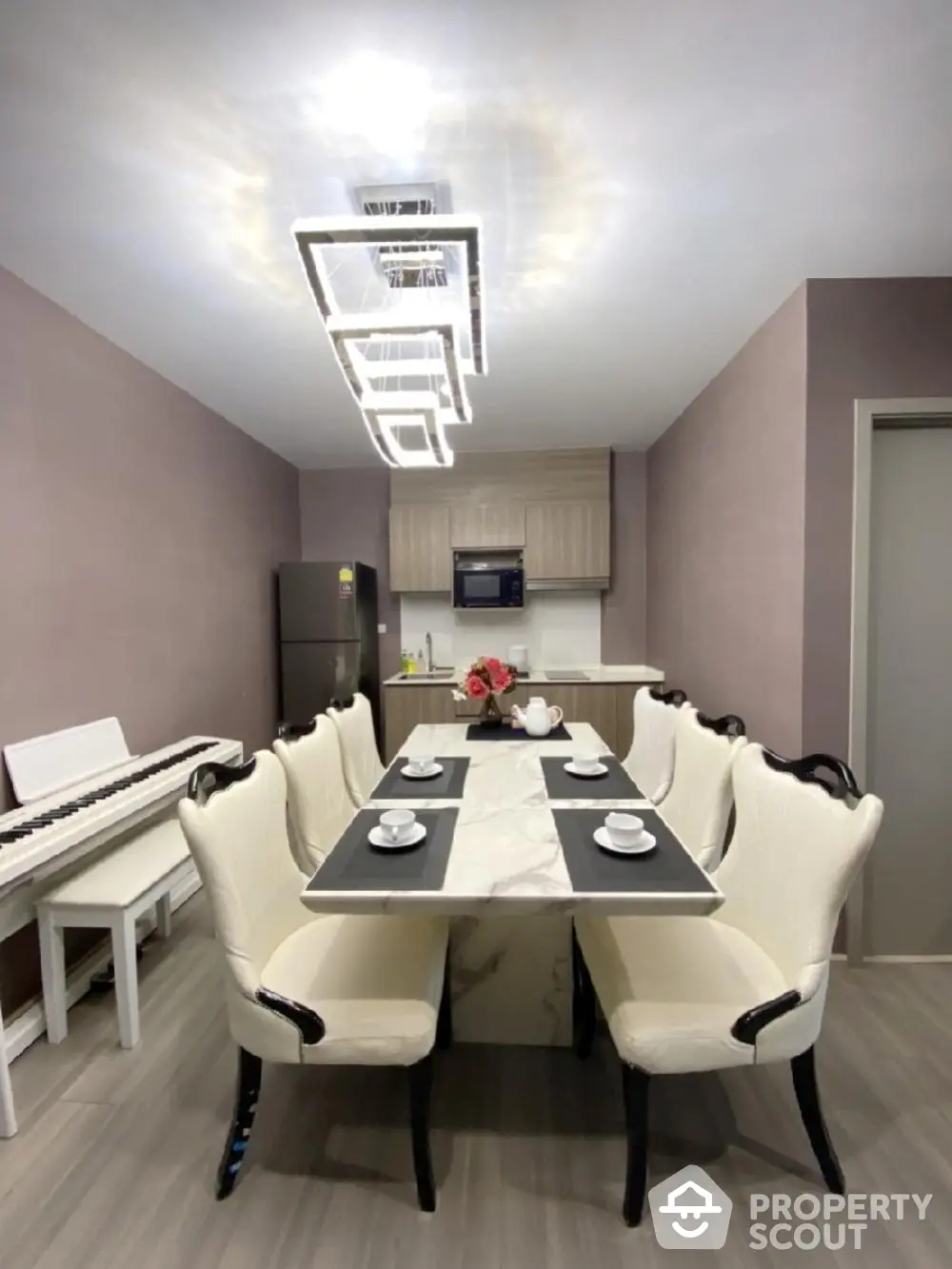 Elegant dining area with modern lighting and sleek kitchen appliances