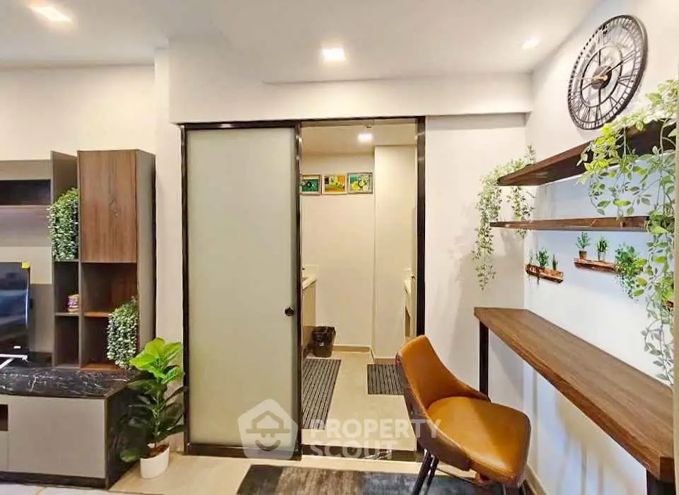 Modern living room with stylish decor and sliding door leading to bathroom