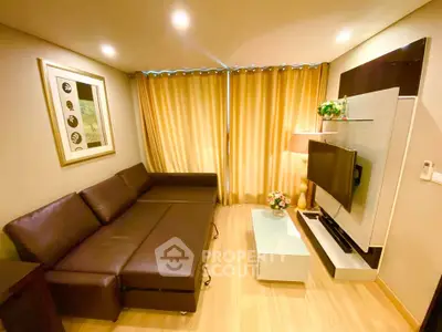 Modern living room with stylish sofa and wall-mounted TV in cozy apartment.