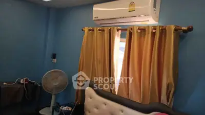 Cozy bedroom with air conditioning and elegant curtains