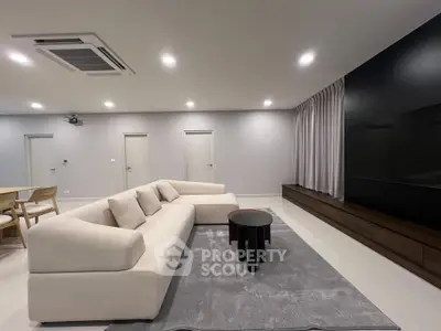Spacious modern living room with elegant sofa and sleek entertainment unit