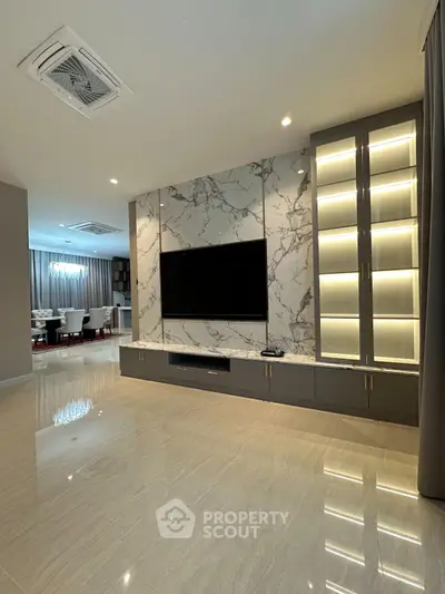 Luxurious modern living room with marble TV wall and elegant lighting